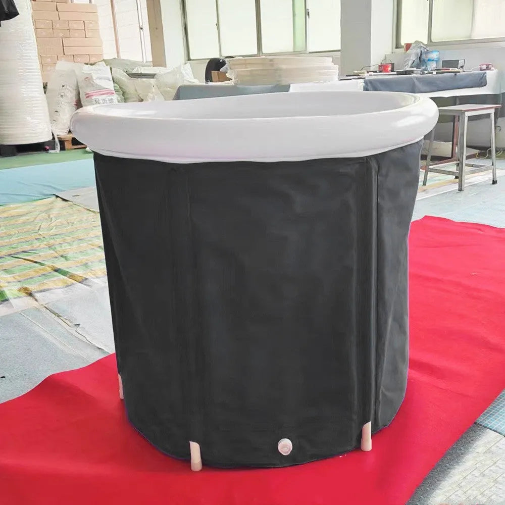 Black inflatable portable ice bath tub with insulation, shown with weather lid and pump.
