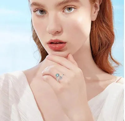 Rotating moonstone ring bracelet in white gold colour with adjustable opening and geometric circle and triangle design