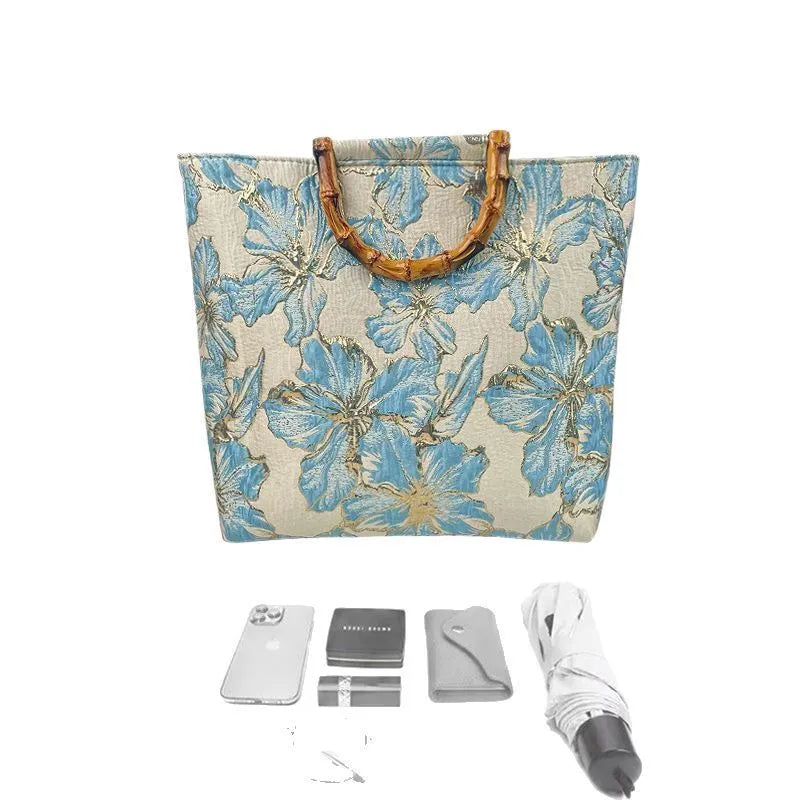 Light blue canvas shoulder bag with gold floral decoration and double shoulder straps