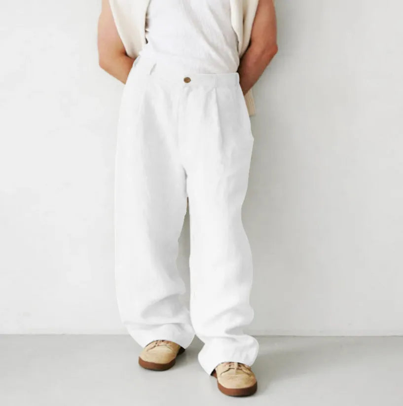 Man wearing loose grey linen high-waist jogger pants with a zip fly, casual style
