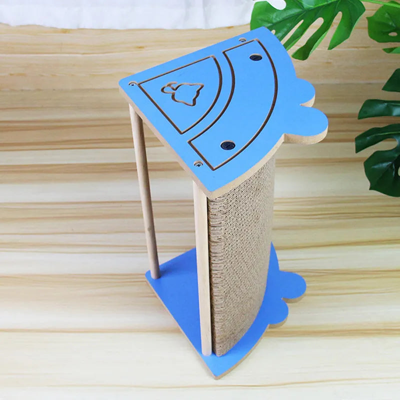 Triangular cardboard cat scratching pad positioned in room corner with hanging ball