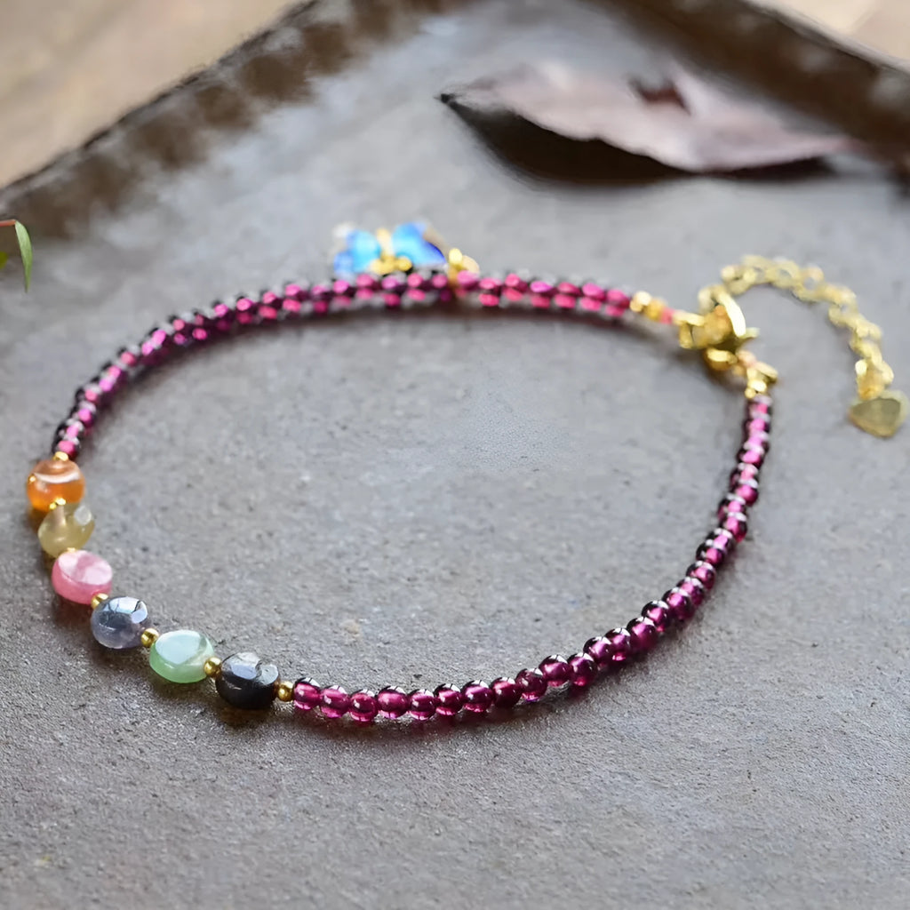 Purple garnet stone bead geometric anklet on an adjustable metal chain.