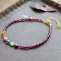 Purple garnet stone bead geometric anklet on an adjustable metal chain.