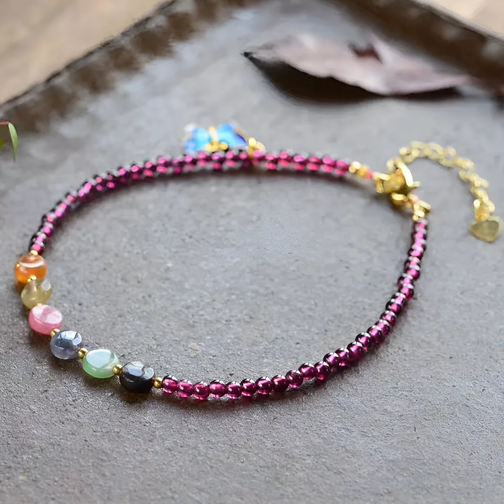 Purple garnet stone bead geometric anklet on an adjustable metal chain.