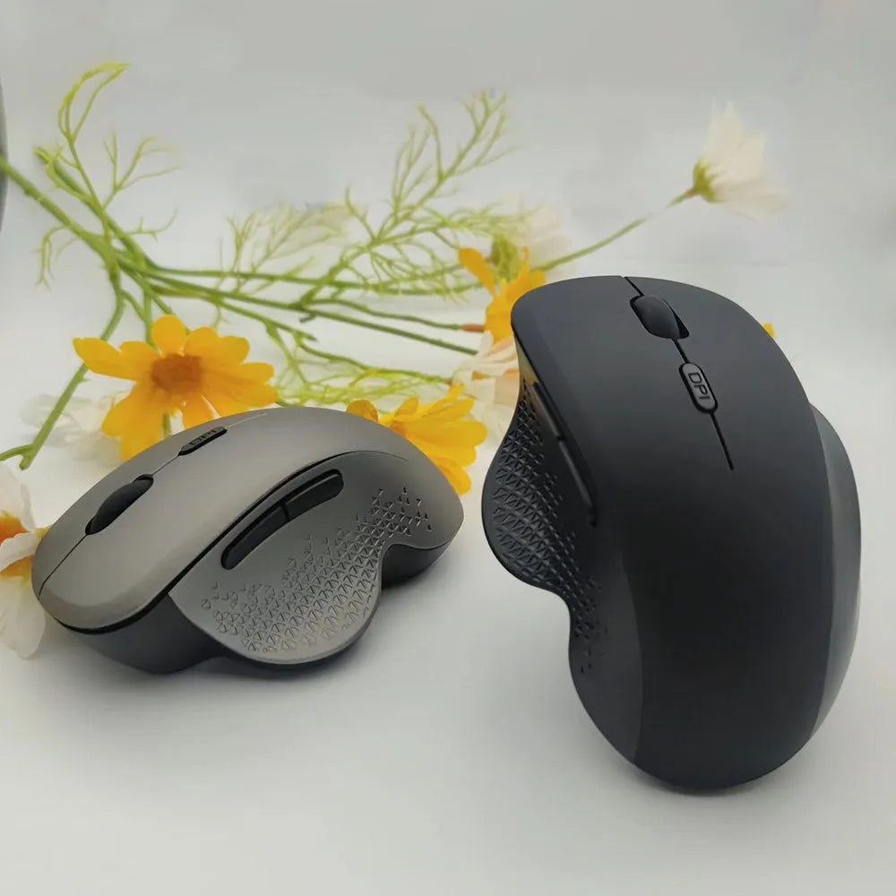 Grey and black self-charging wireless laptop mouse with USB cable on white background