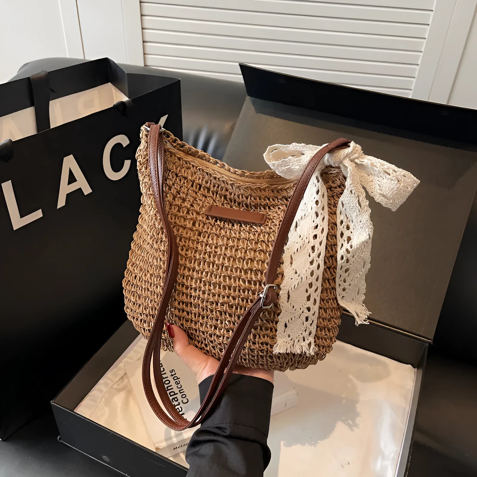 Women's woven straw shoulder messenger bag in khaki with zip pocket and single strap.