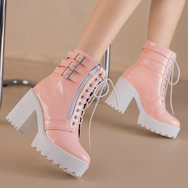 Women's black thick-heeled short boots with lace-up front and round toe on a rubber sole.