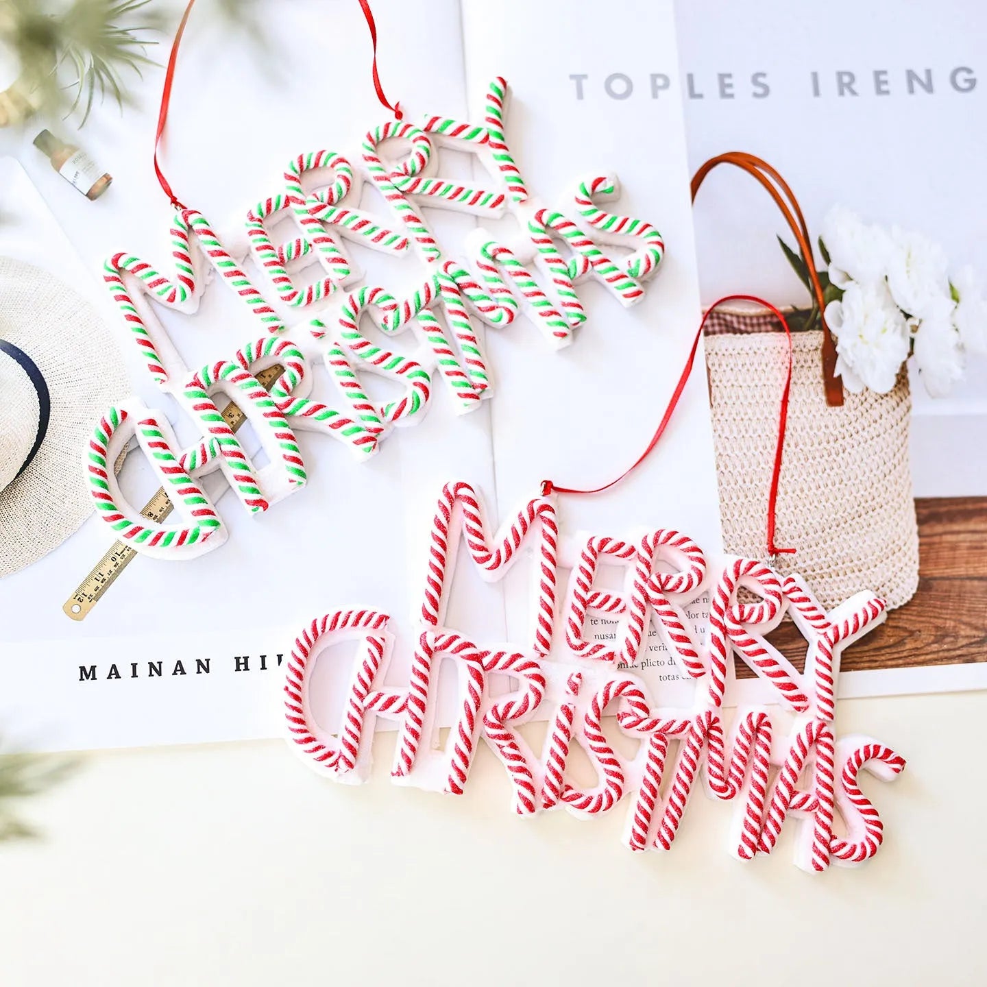 Merry Christmas letter plate polymer clay ornament in red and white hanging on Christmas tree branch