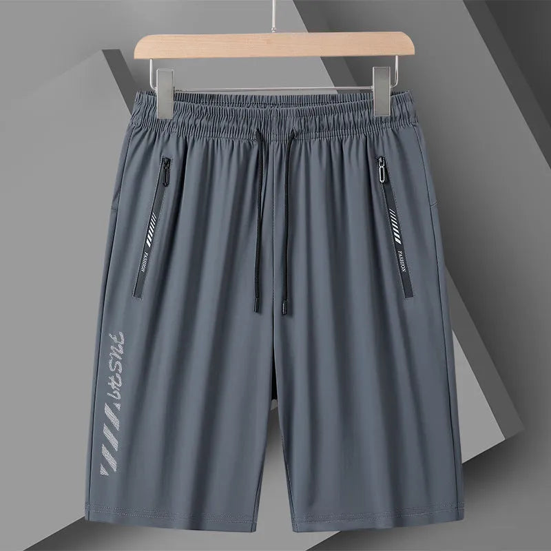 Man wearing black loose-fit quick-drying nylon sports shorts with an elastic waistband.