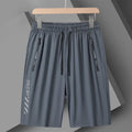 Man wearing black loose-fit quick-drying nylon sports shorts with an elastic waistband.