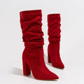 Women's black suede pointed-toe boots with a chunky high heel and pile-style ankle cuff.