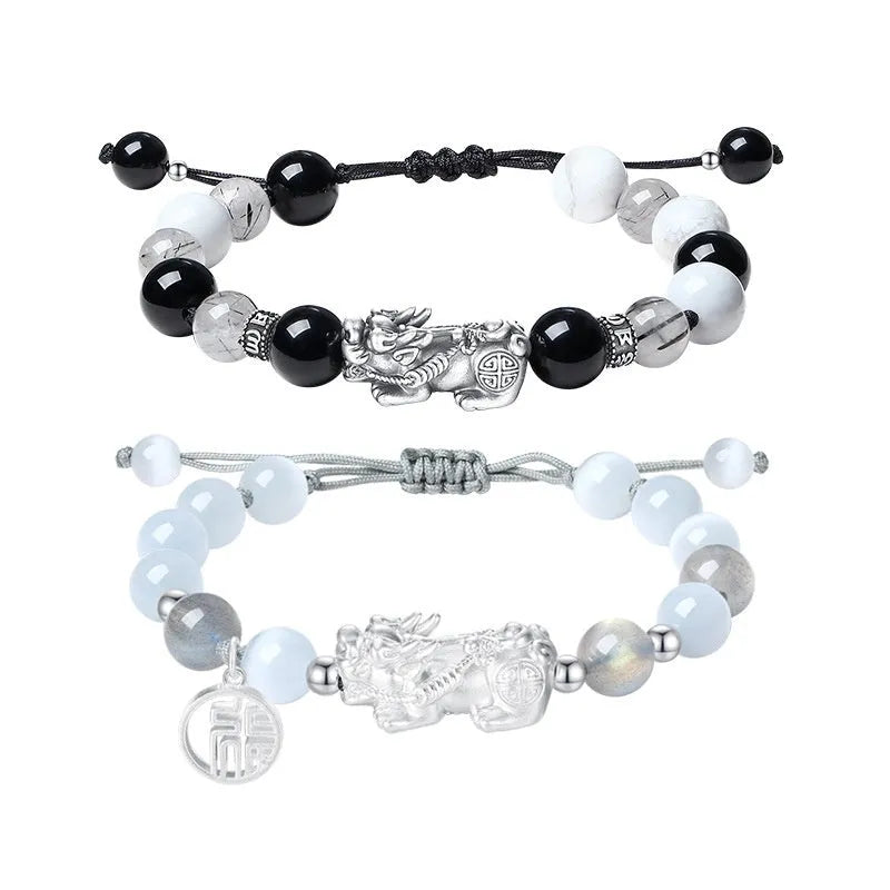 Hand-woven couple bracelet with sterling silver blessing card in black, white, or set, featuring animal and tassel details.