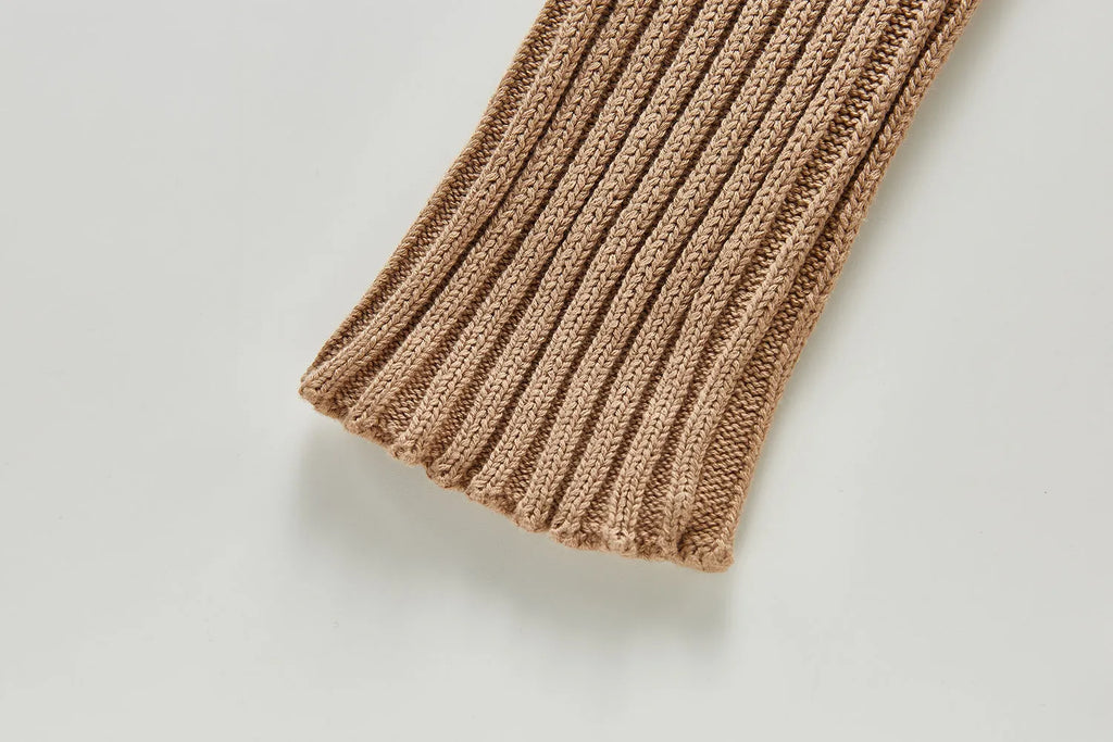 Baby long-sleeved knitted jumpsuit romper pullover in beige, size 80cm, lying flat on a white background