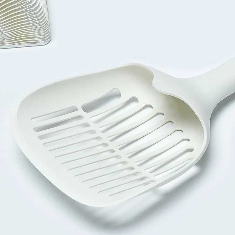 White plastic cat litter scoop with a storage base, shown with dimensions 29.5cm by 12.8cm.