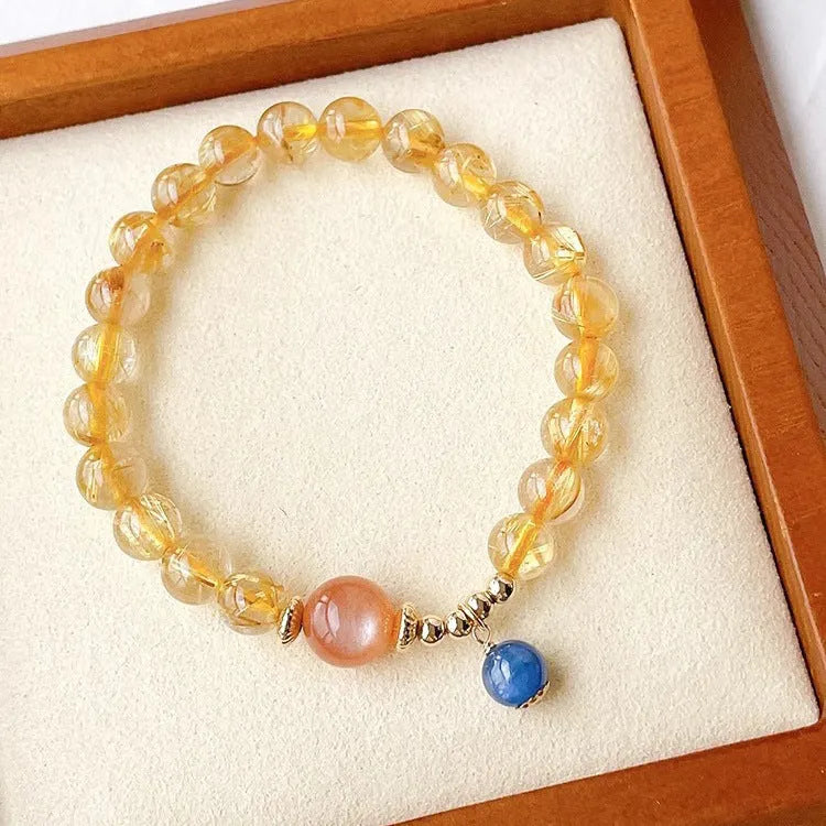 Women's gold rutilated quartz sunstone crystal bracelet with diamond-shaped and round beads