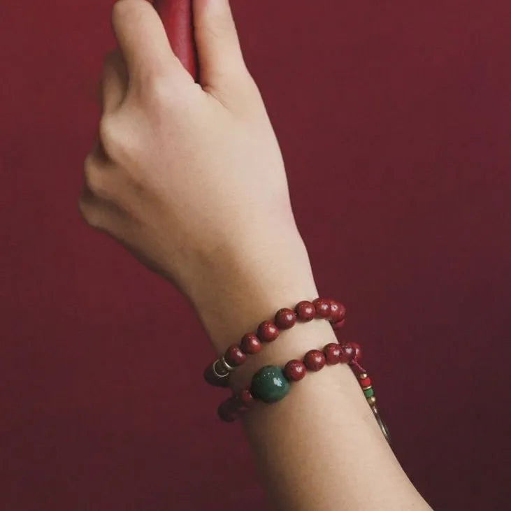 Close-up of a handmade double circle bracelet crafted from brown bodhi seeds on a wrist.