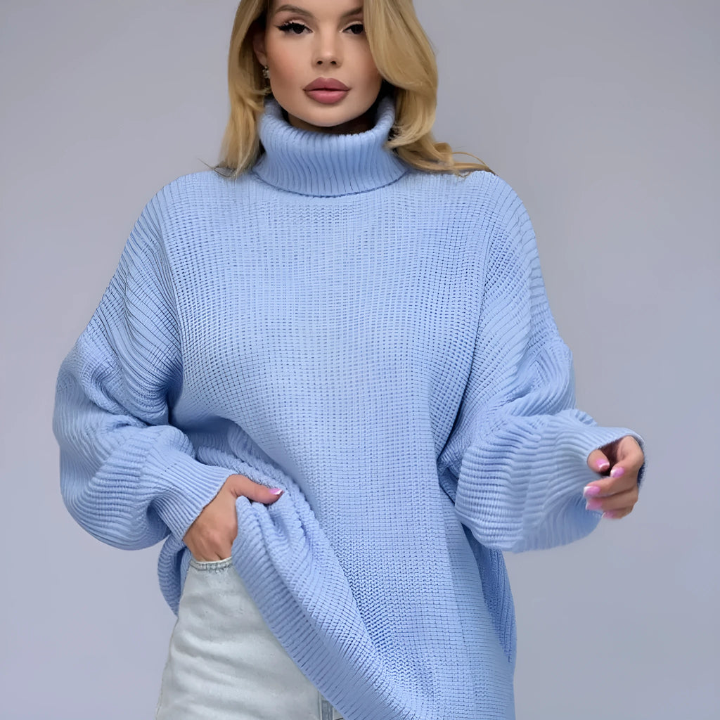 Women's loose fit high neck pullover sweater in solid sky blue colour, showing 3D textured pattern.