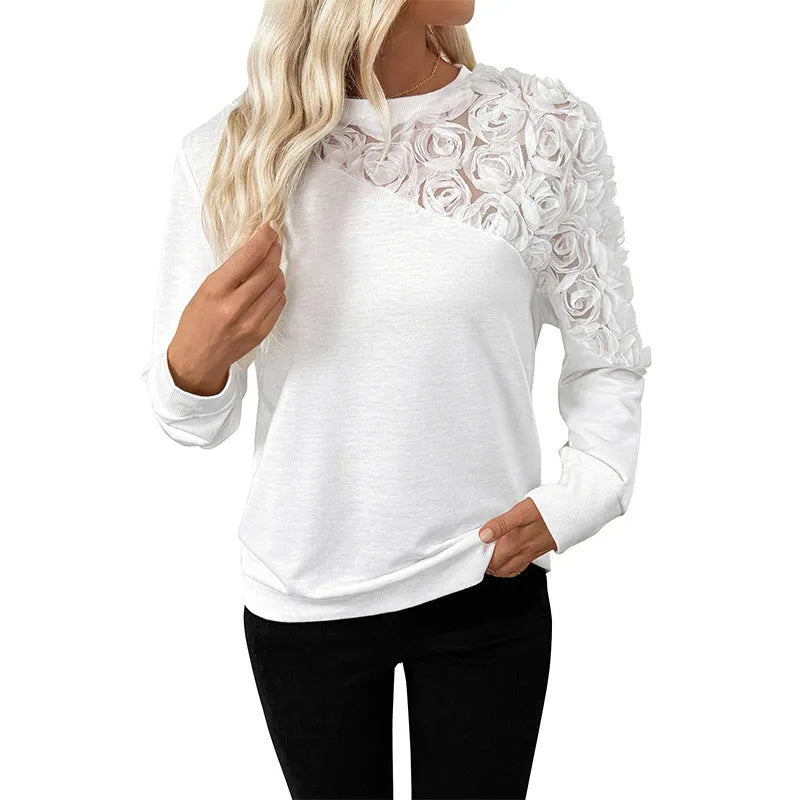 White long sleeve pullover top with floral pattern showing loose fit and regular sleeve design