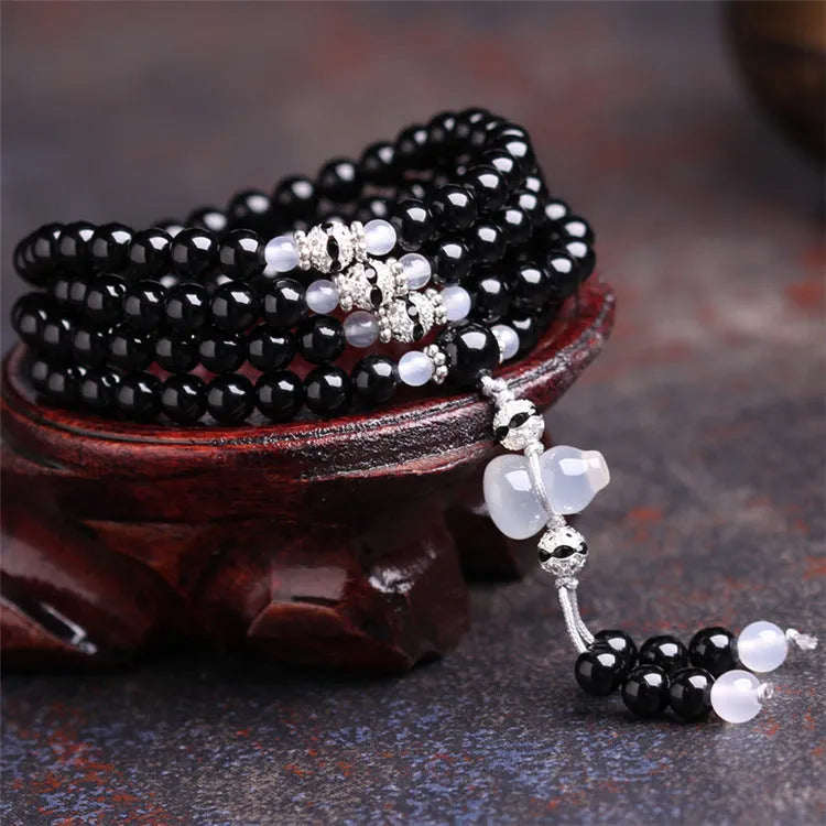 Natural black agate bracelet with 108 beads showing geometric shapes and numeric design elements