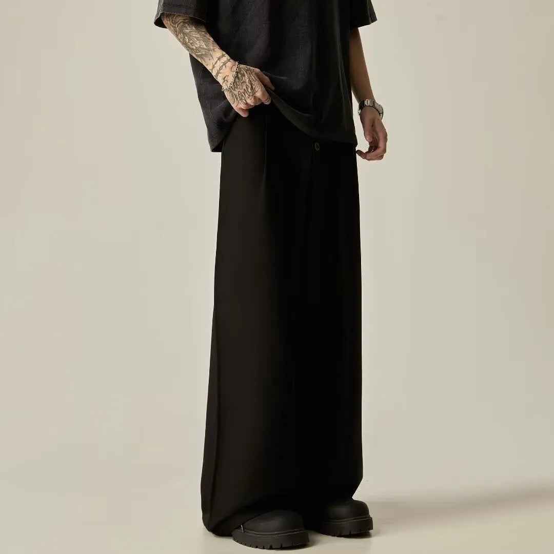 Men's solid black wide-leg casual trousers with a vertical tube design on a mid-waist.