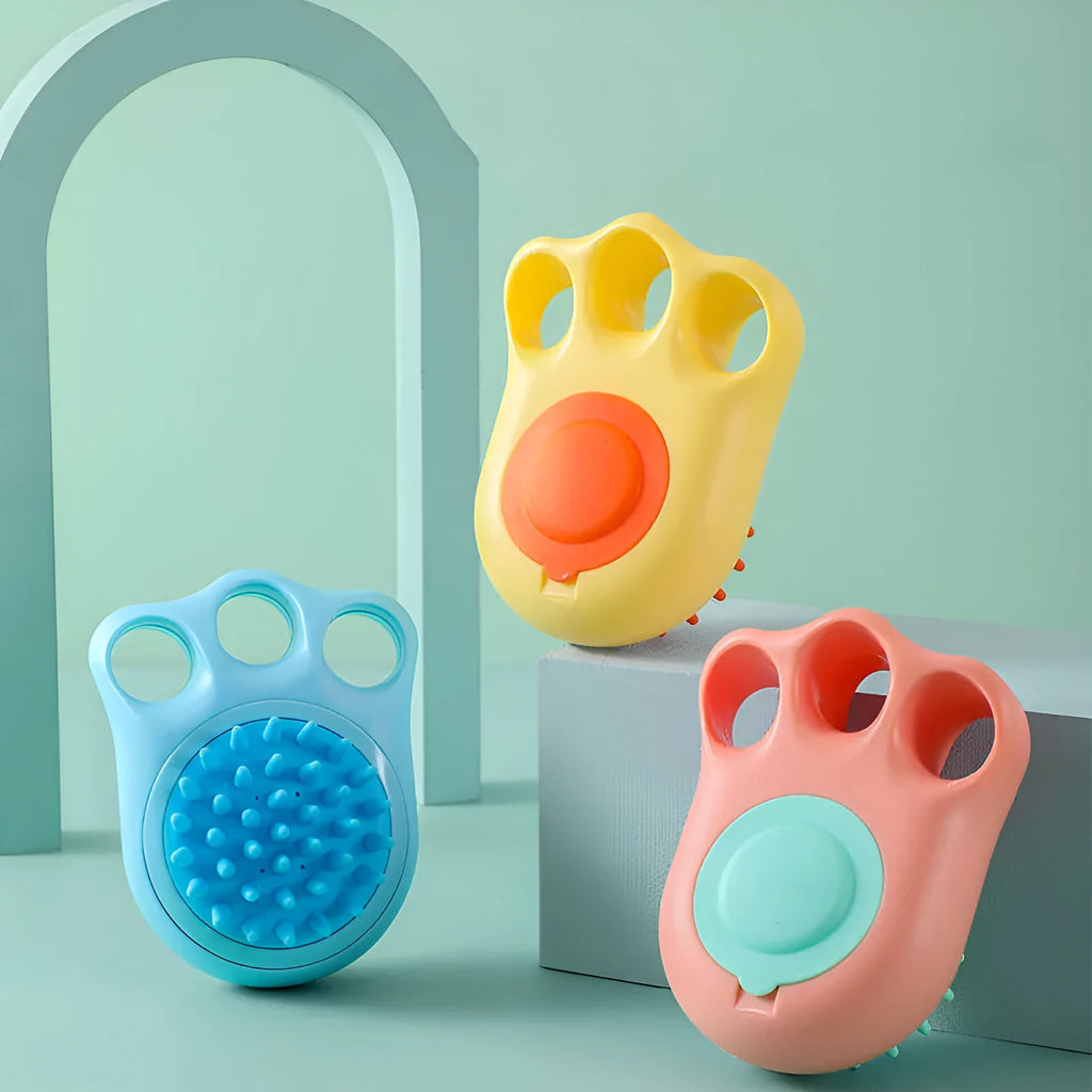 Claw-shaped silicone bath brush for dogs and cats in blue, pink, white, or yellow.
