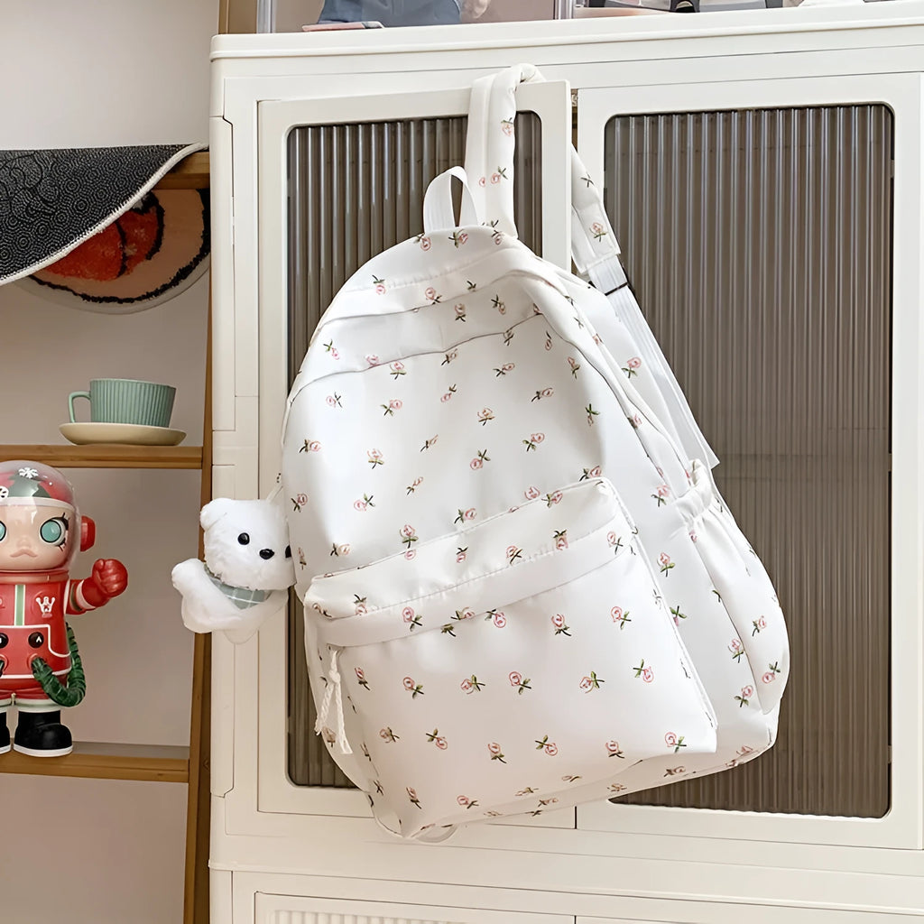 Japanese-style floral print girls' backpack in Oxford cloth with curved shoulder straps, shown in pink floral or white tulip scarf bear.