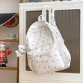 Japanese-style floral print girls' backpack in Oxford cloth with curved shoulder straps, shown in pink floral or white tulip scarf bear.