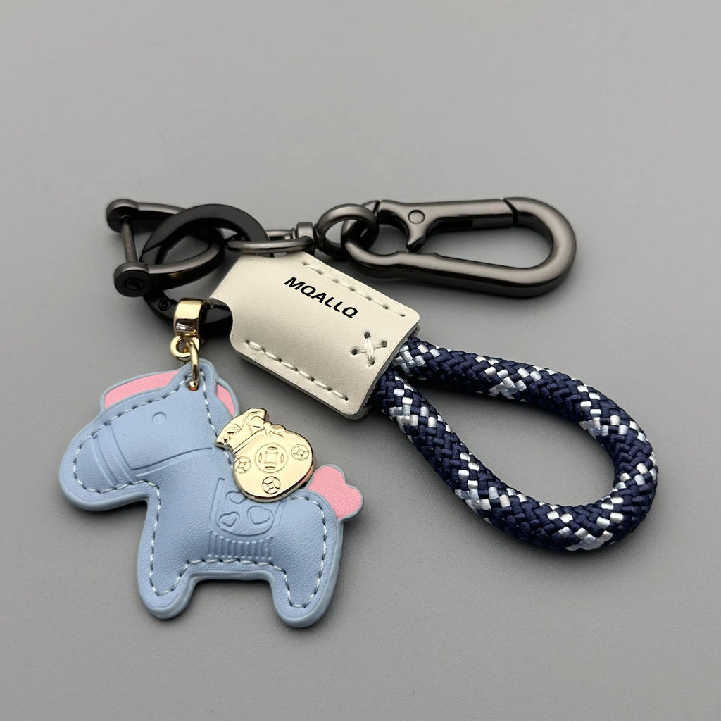 Handmade brown cowhide leather keychain with a zinc alloy pony belt buckle on a green flanelle rope.
