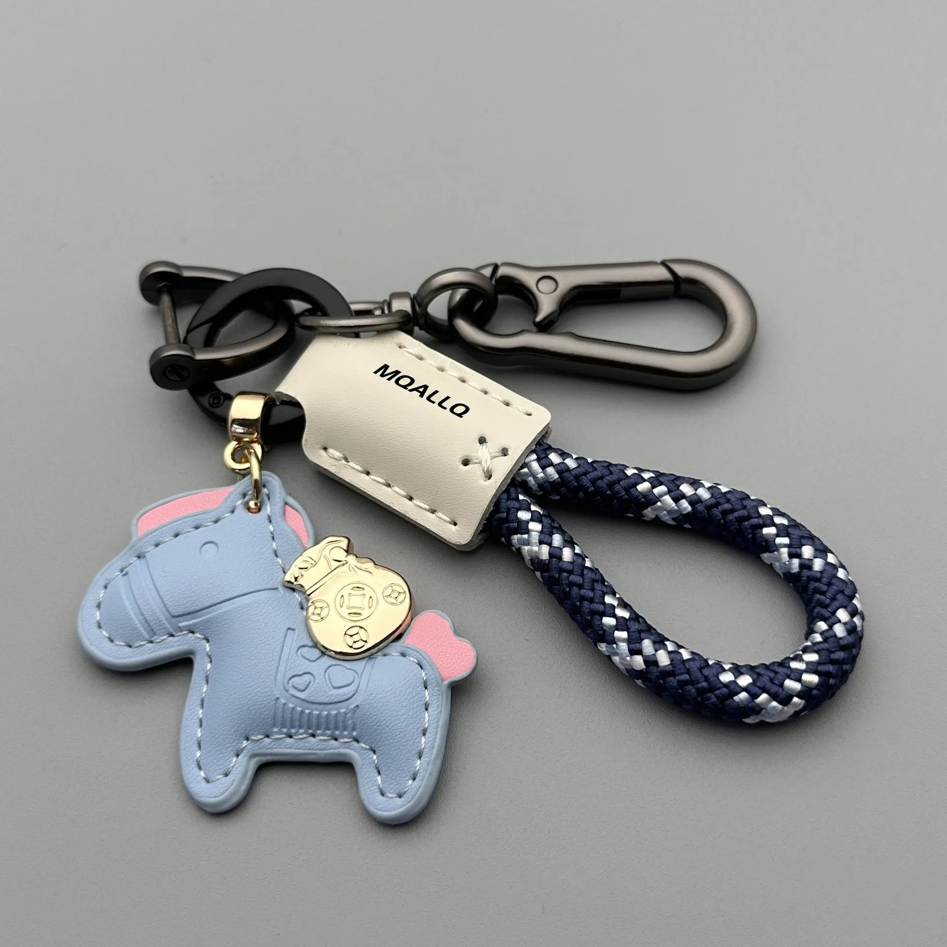 Handmade brown cowhide leather keychain with a zinc alloy pony belt buckle on a green flanelle rope.
