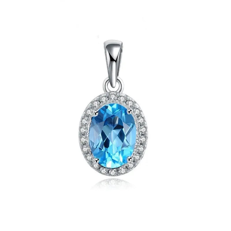 Four-piece sterling silver jewellery set with blue topaz: geometric earrings, ring, pendant, and necklace.