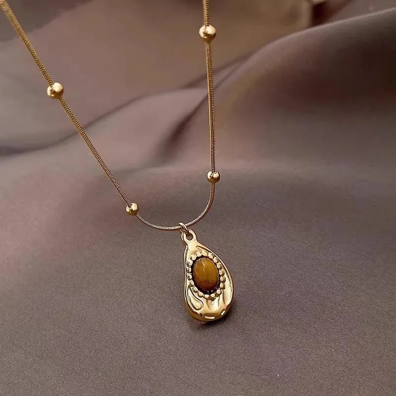 Gold titanium steel clavicle necklace with irregular amber tiger eye stone pendant
