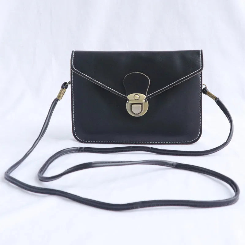 Soft surface crossbody messenger bag with flap closure and lock hardware in wine red colour