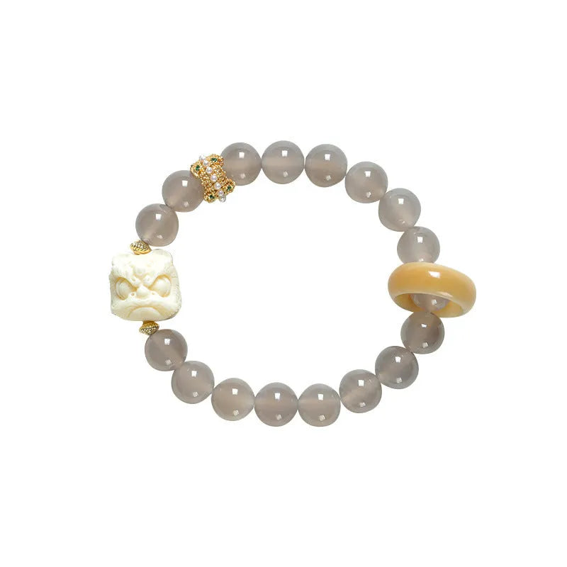 Hand-woven bracelet with 10mm round grey agate and mellite beads on a single strand.