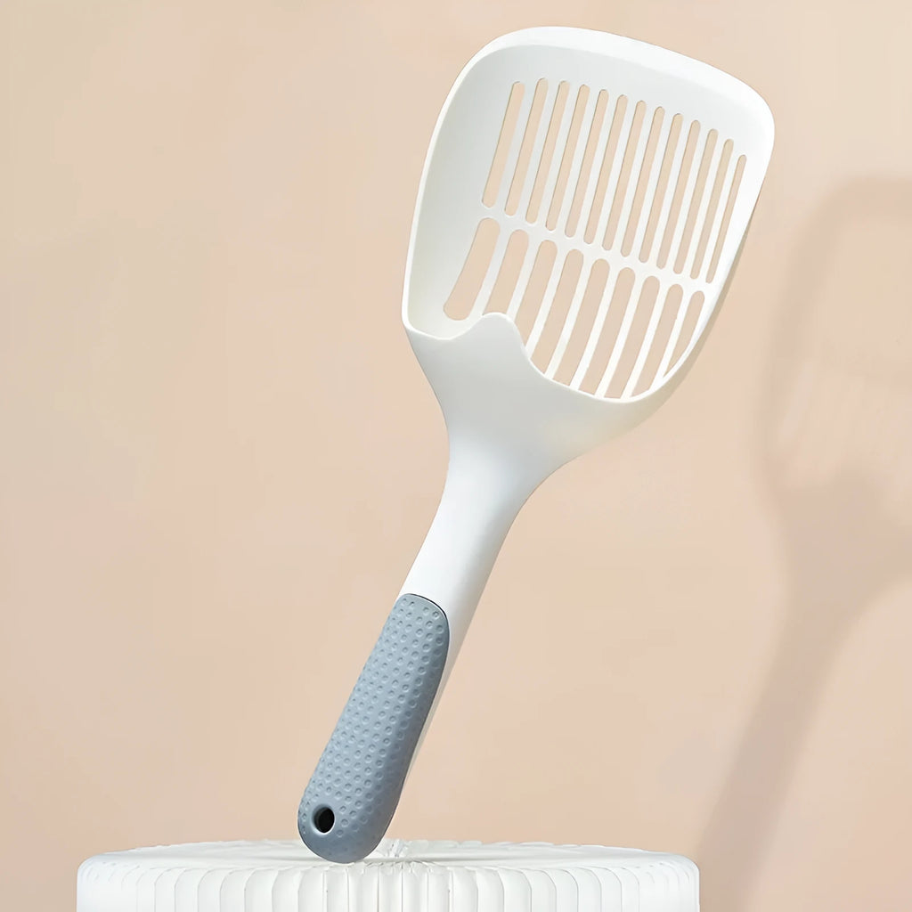 White plastic cat litter scoop with a storage base, shown with dimensions 29.5cm by 12.8cm.