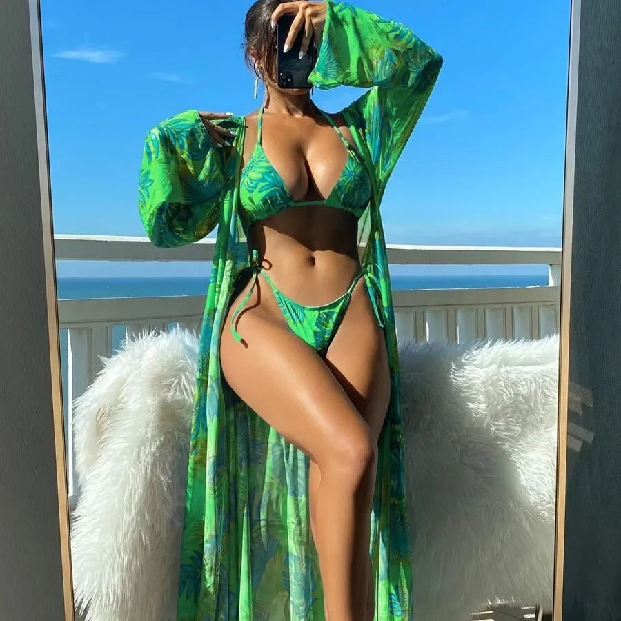 Blue long sleeve bikini set with banded briefs and a matching outer robe laid flat