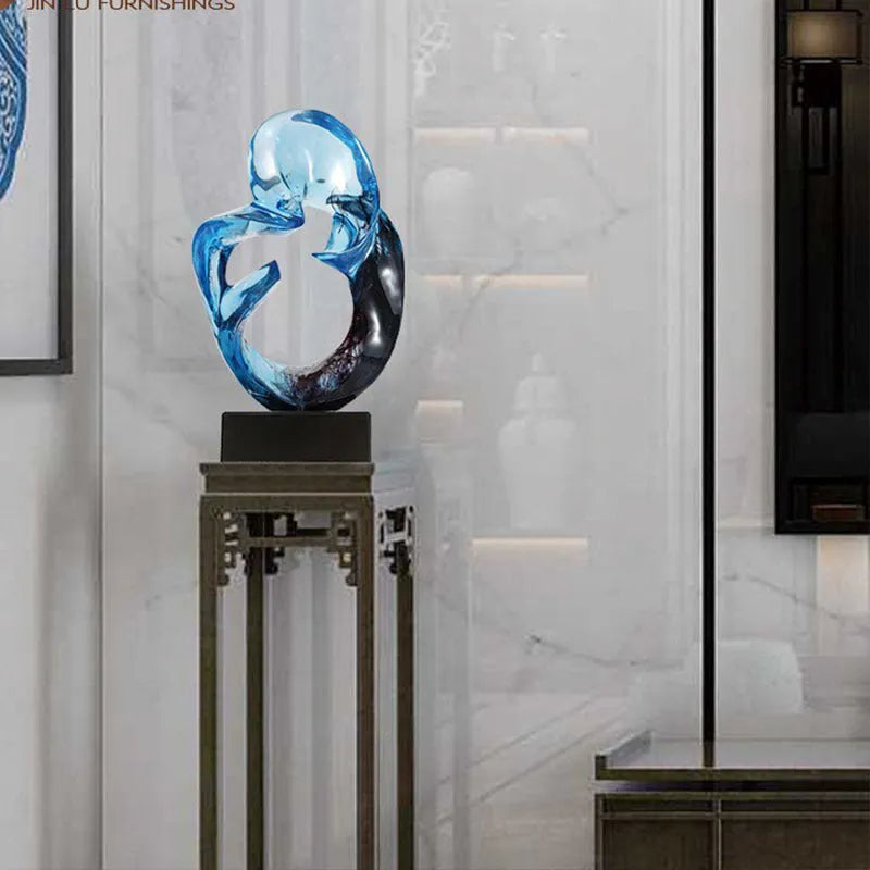 Transparent resin sculpture ornament in blue colour on display surface