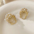 Gold-coloured copper flower basket earrings with small rice-shaped beads and pearl inlay detailing.