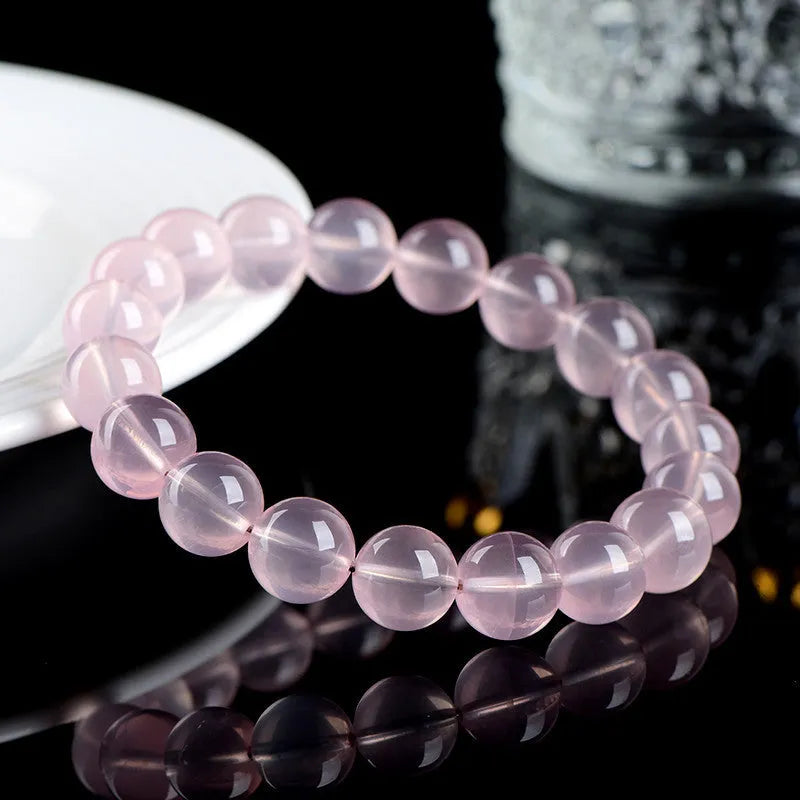 Crystal bracelet with polished pink round beads in natural starlight design showing single circle construction