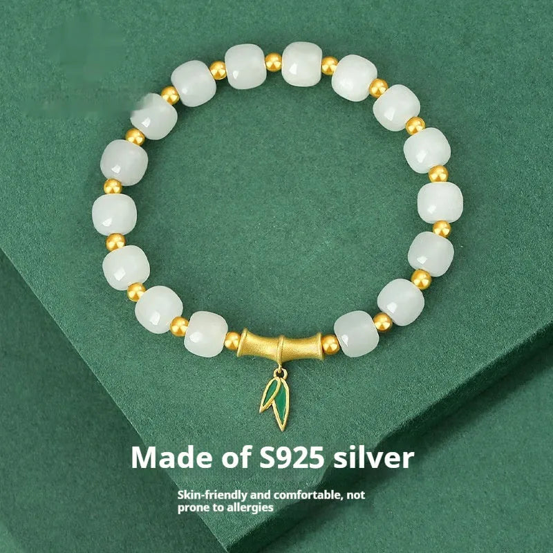 S925 sterling silver bracelet with round Hetian jade beads and bamboo leaf charms.