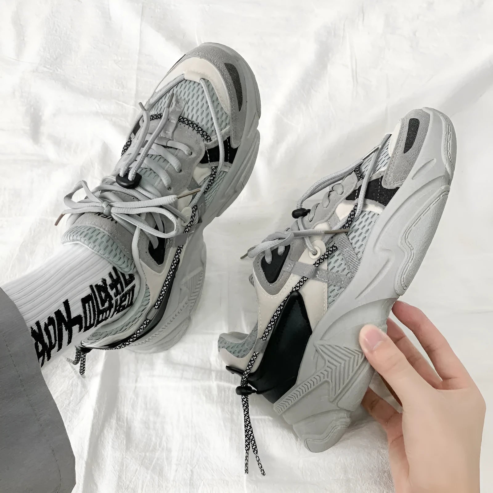 Men's white Korean-style platform dad shoes with thick sole and lace-up front on a plain background