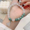 Close-up of a women's retro style agate bracelet with a lotus seedpod design.