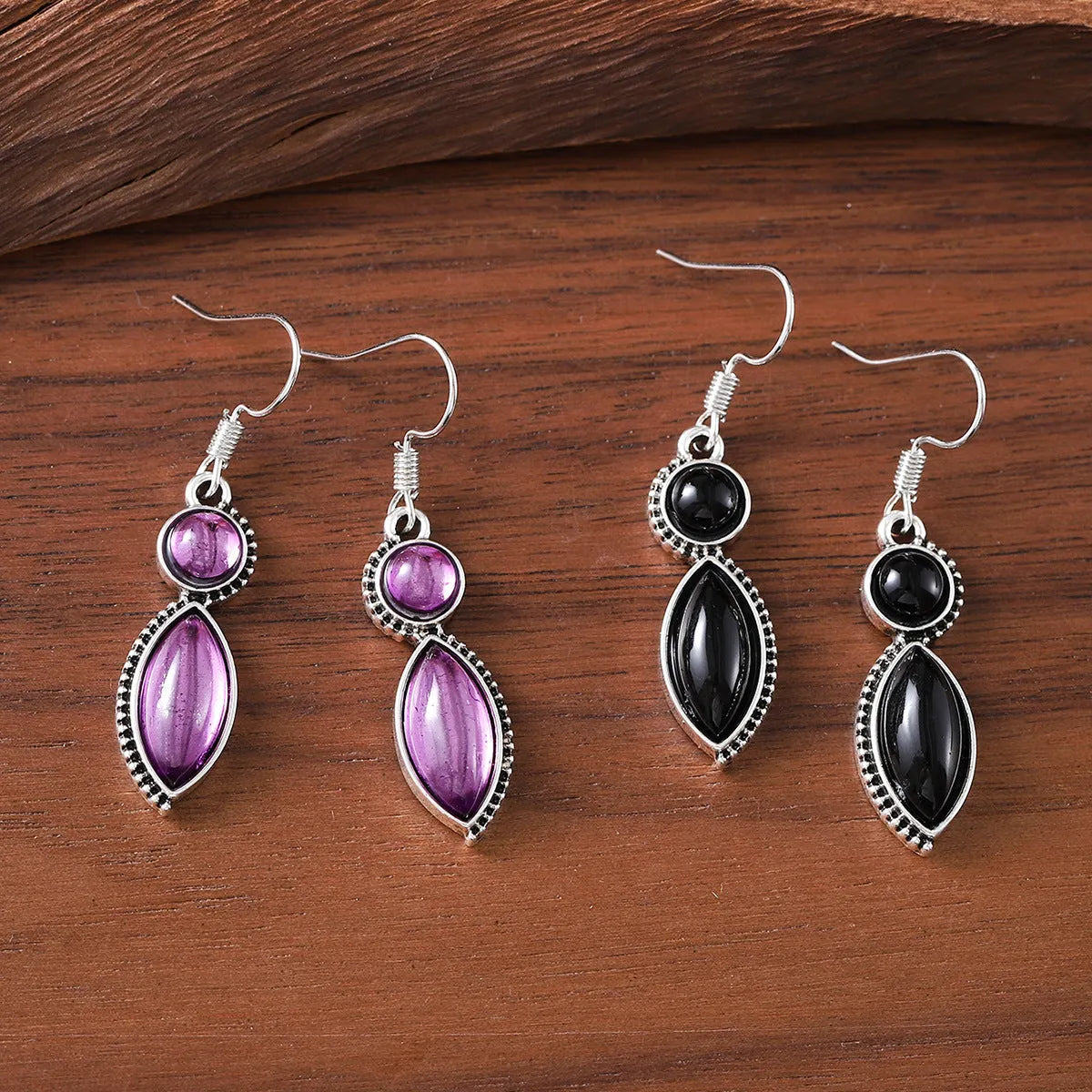 A pair of vintage geometric pendant earrings in black and purple with a round detail, made from zinc alloy.