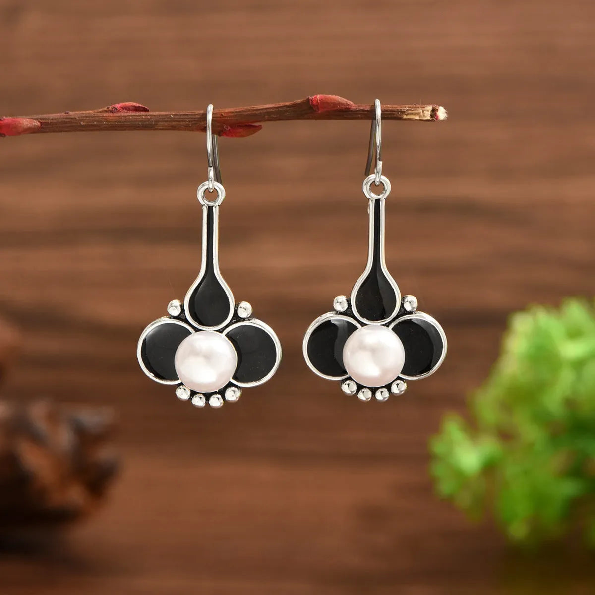 A pair of silver retro fashion alloy earrings for women with an electroplated finish.