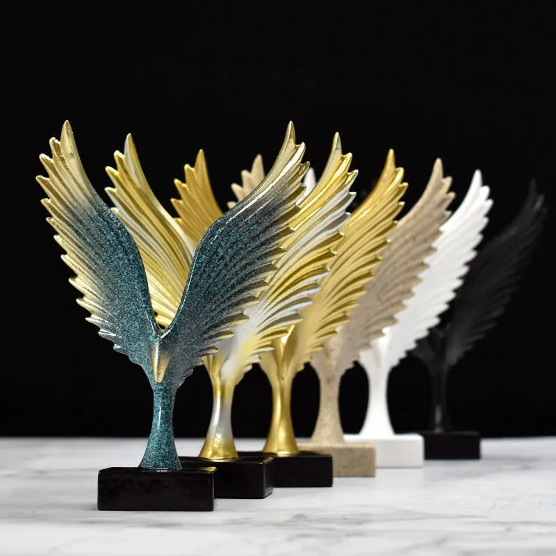 Mini synthetic resin decoration in silver and gold angel wing style on a shelf