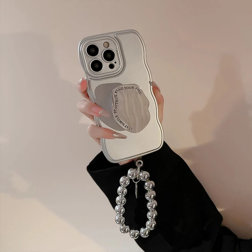 Silver metal bracket phone case for iPhone with electroplated finish and hand bead detail on gray background