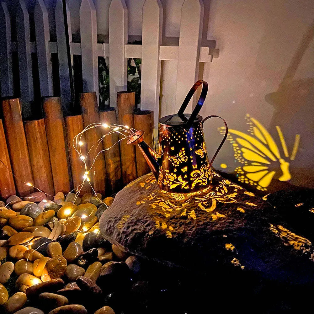 Iron solar garden lamp with tapered butterfly pattern and warm white LED light.