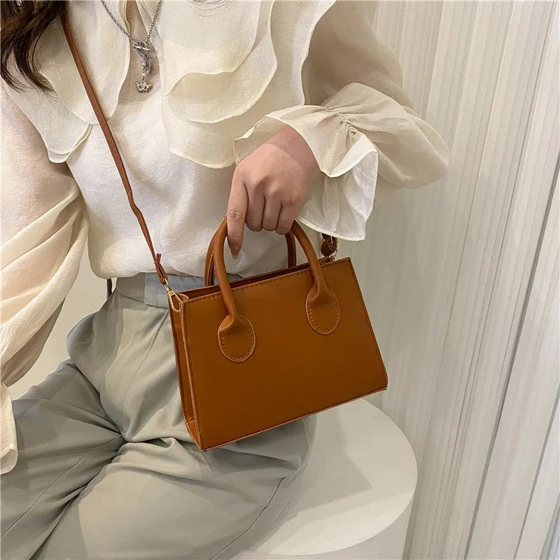 Women's black PU leather horizontal square shoulder bag with single strap and sewing line detailing