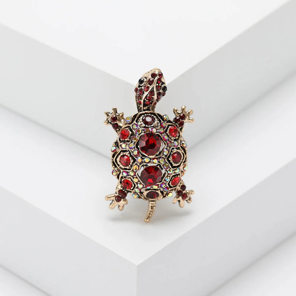 Retro-style alloy turtle brooch with rhinestone decoration, shown in blue colour.