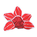Dog wearing green and red Halloween chomper costume with demon hat headband and colourful flowers