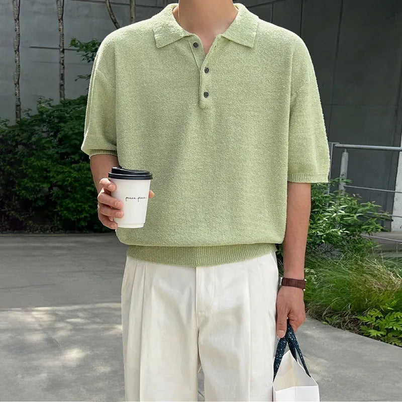 Men's caramel coloured retro knitted polo shirt with short sleeves and an asymmetrical design detail, laid flat.